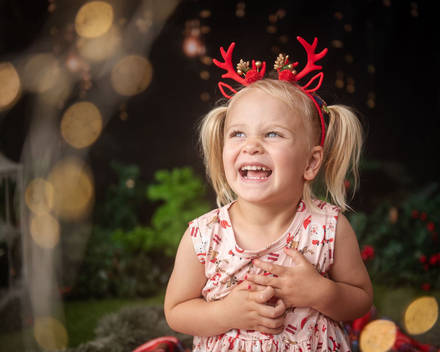 Holiday themed portraits with reindeer antler accessories and bokeh lighting effects.