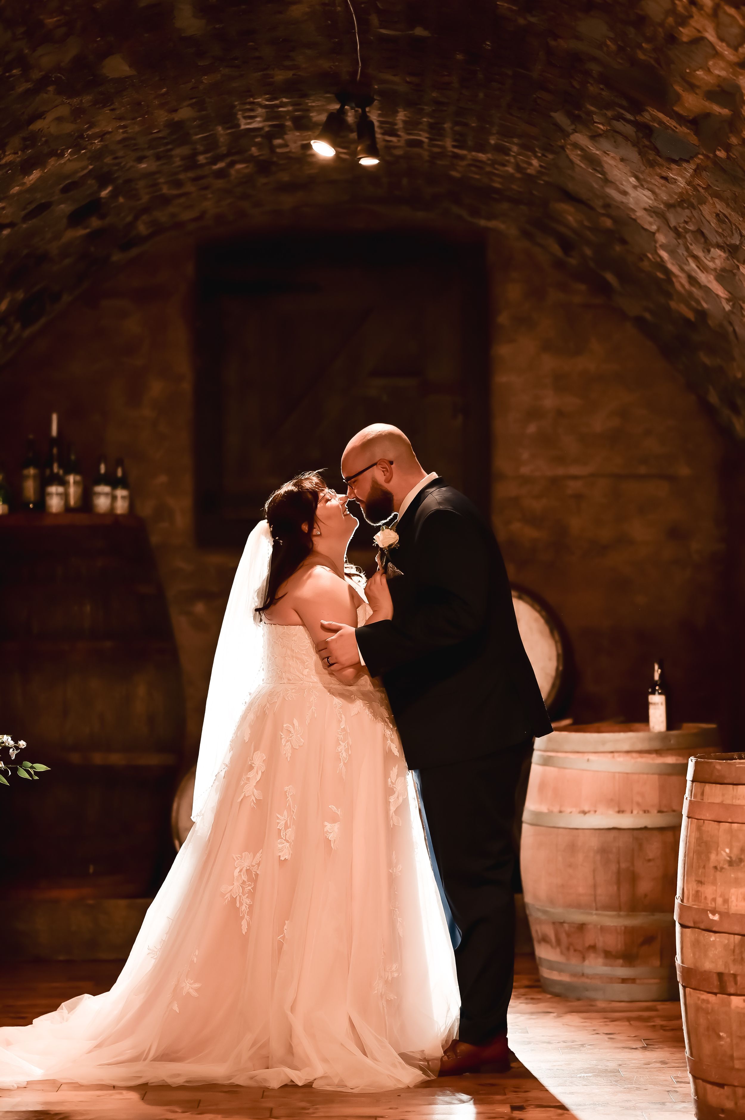 A couple embracing on a rainy day during their wedding photoshoot at Newman's Wine Vaults, St. John's, Newfoundland