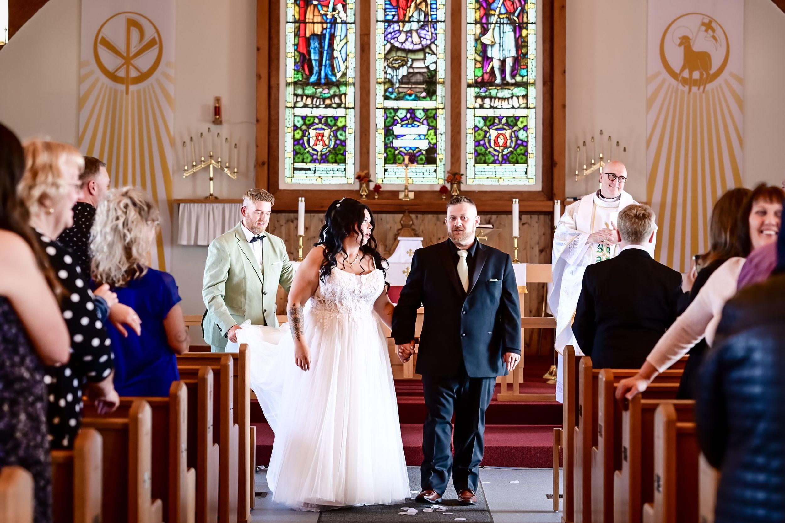 Bride and groom at Arnolds Cove Church with stained glass windows