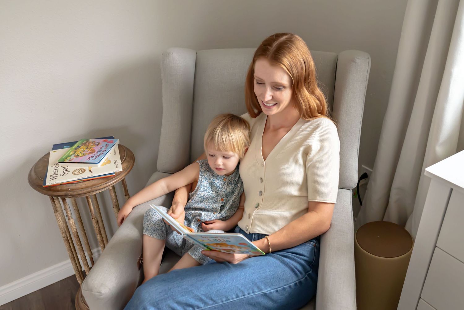 Medium close-up of a mother reading to her child. In-home family photography. Doughman Photography.