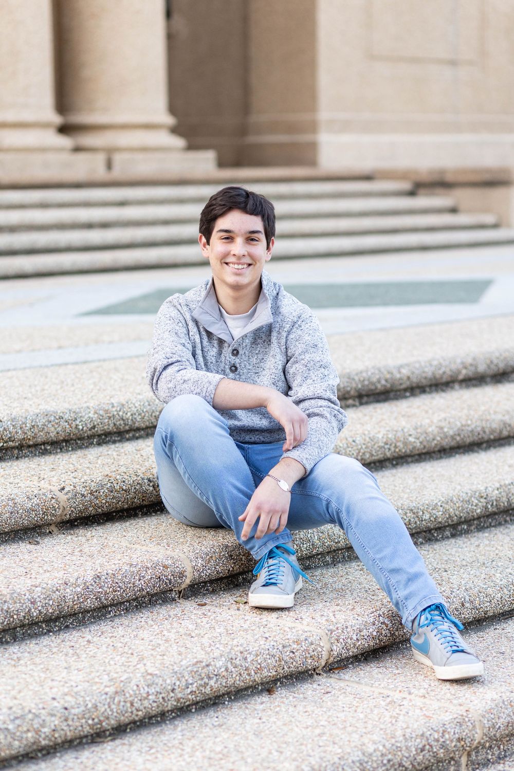 senior boy sitting on steps