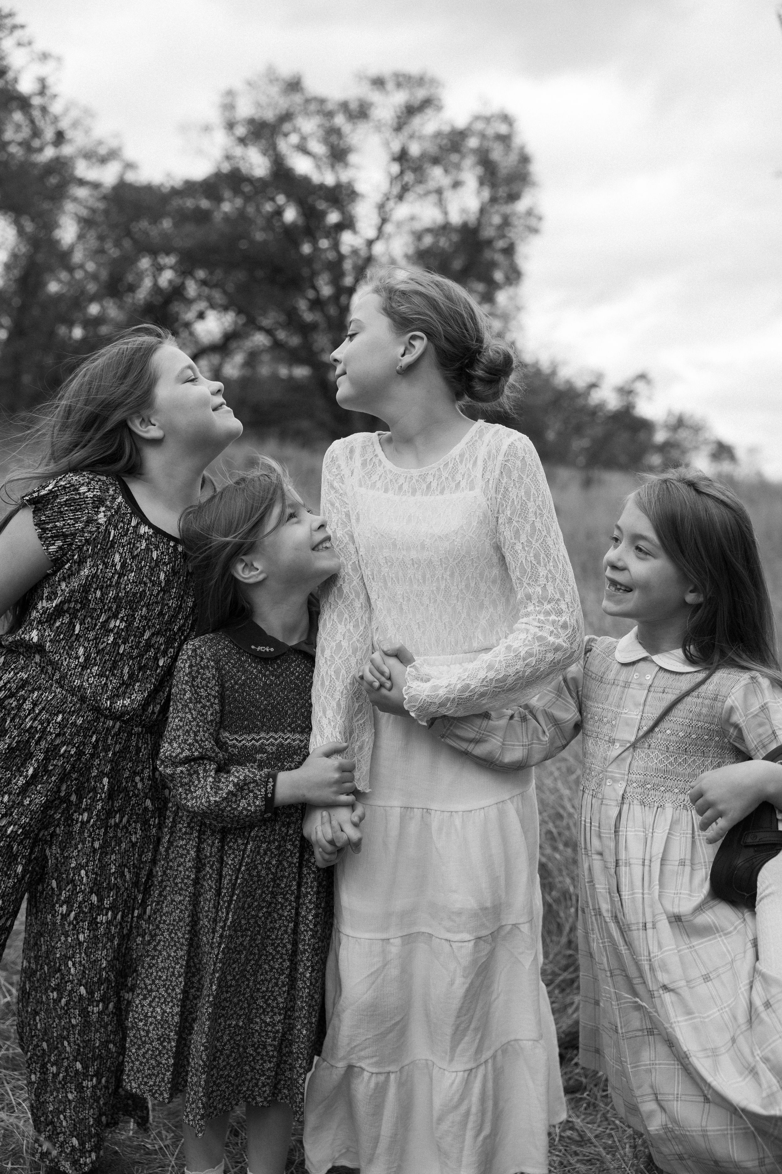 Three black and white sequential images show intimate family interactions captured in a candid, playful style.