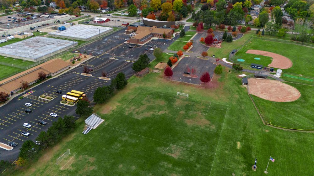 An aerial view of a parking lot and sports field