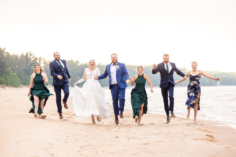 Wedding party skipping on the beach