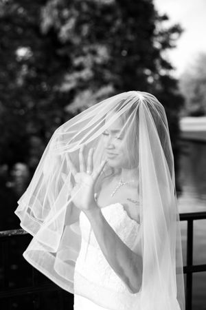 A bride in a white wedding dress and veil shown in a series of black and white photos with soft focus.