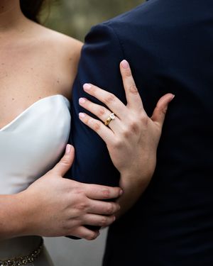 Close-up of hands embracing during an intimate wedding moment.