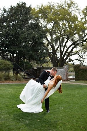A romantic dip pose sequence showing a couple in formal wedding attire on a lush green lawn with trees in the background.