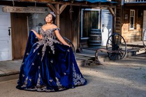 Stunning blue and silver formal gown displayed in a rustic western town setting. blomgren ranch.