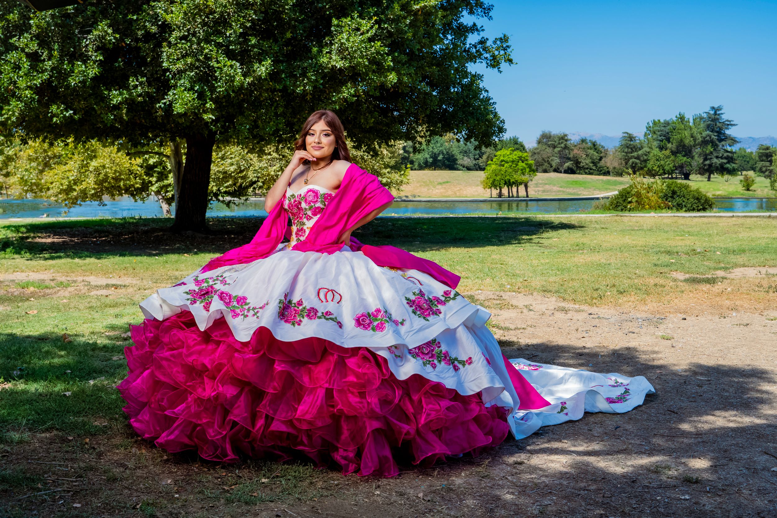 Flowing quinceañera gown with magenta tulle and white details photographed in natural lighting. Los angeles.