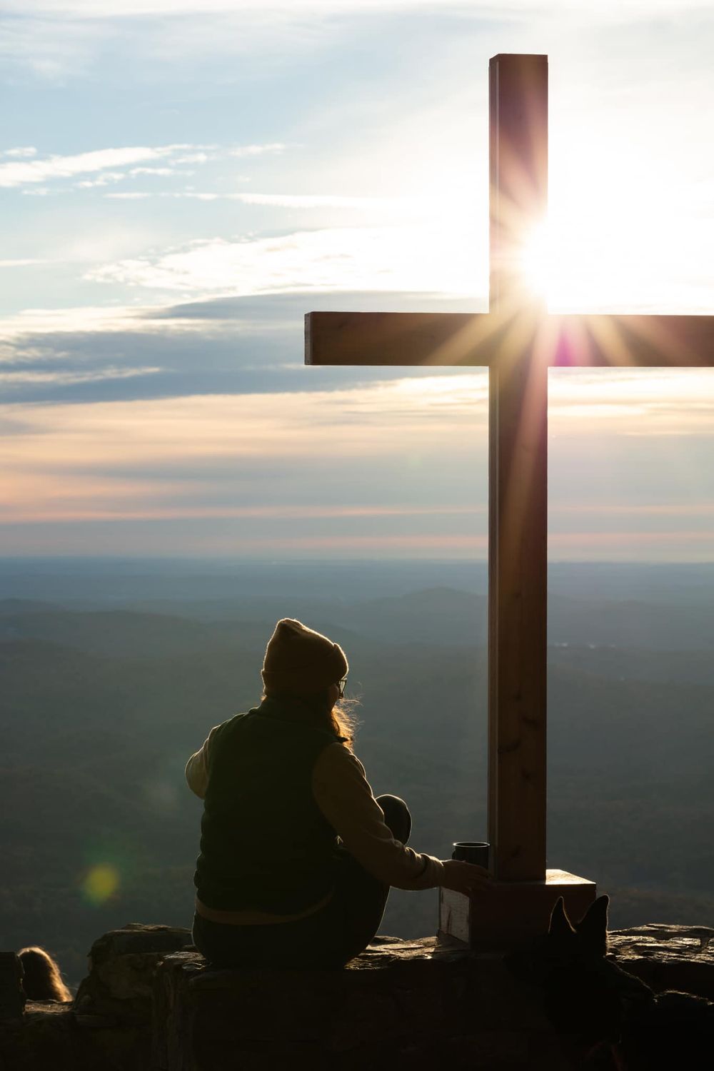 Silhouetted figures rest beside a cross at Pretty Place in South Carolina.