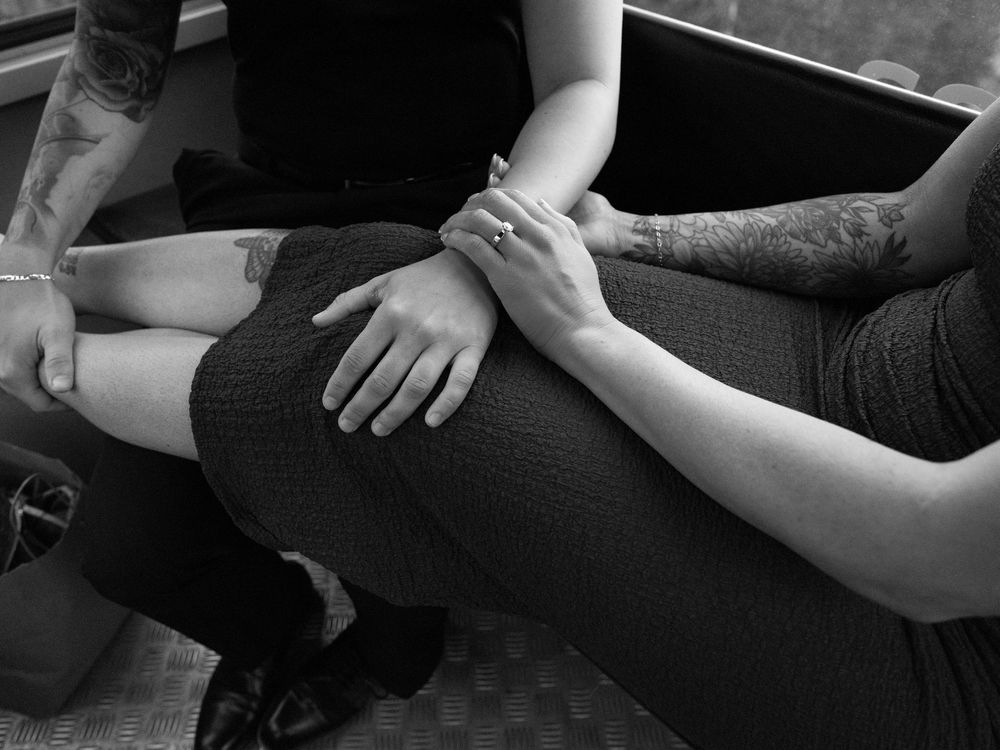 Close-up black and white photo of hands holding and touching each other in various positions.