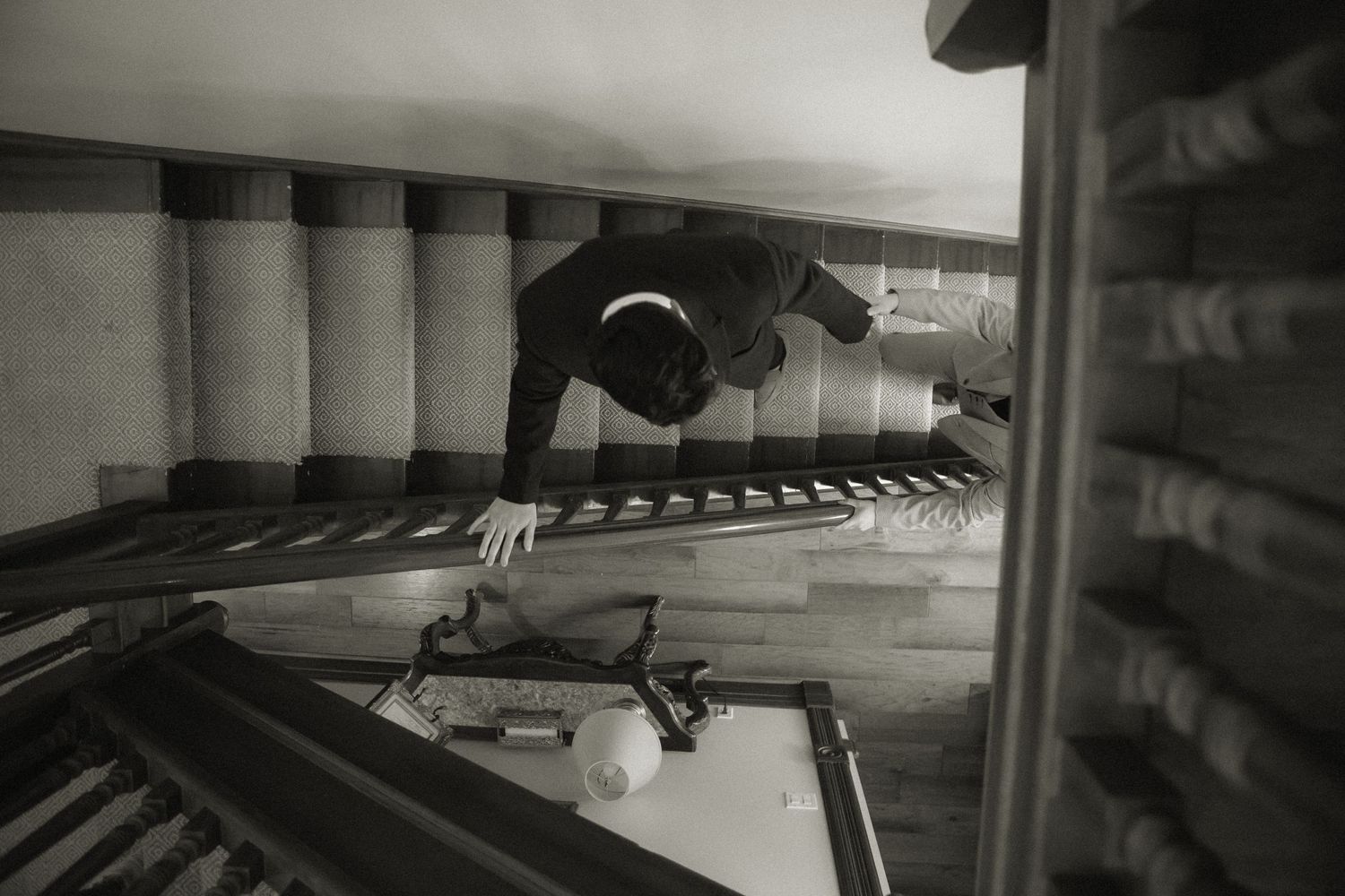 Black and white image showing an artistic perspective shot of stairs with a dramatic composition.