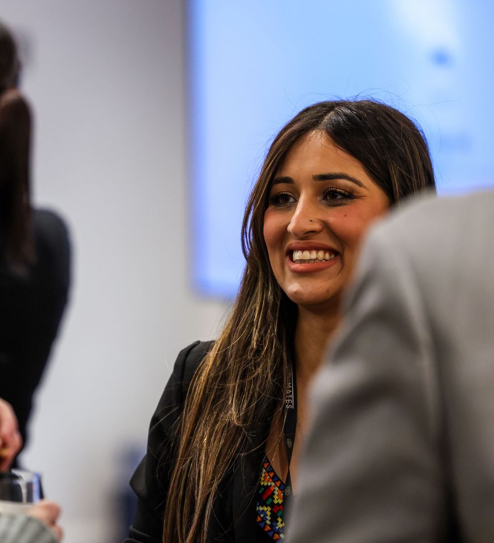 A series of blurred profile shots showing long dark hair and smiling expressions against a light background.