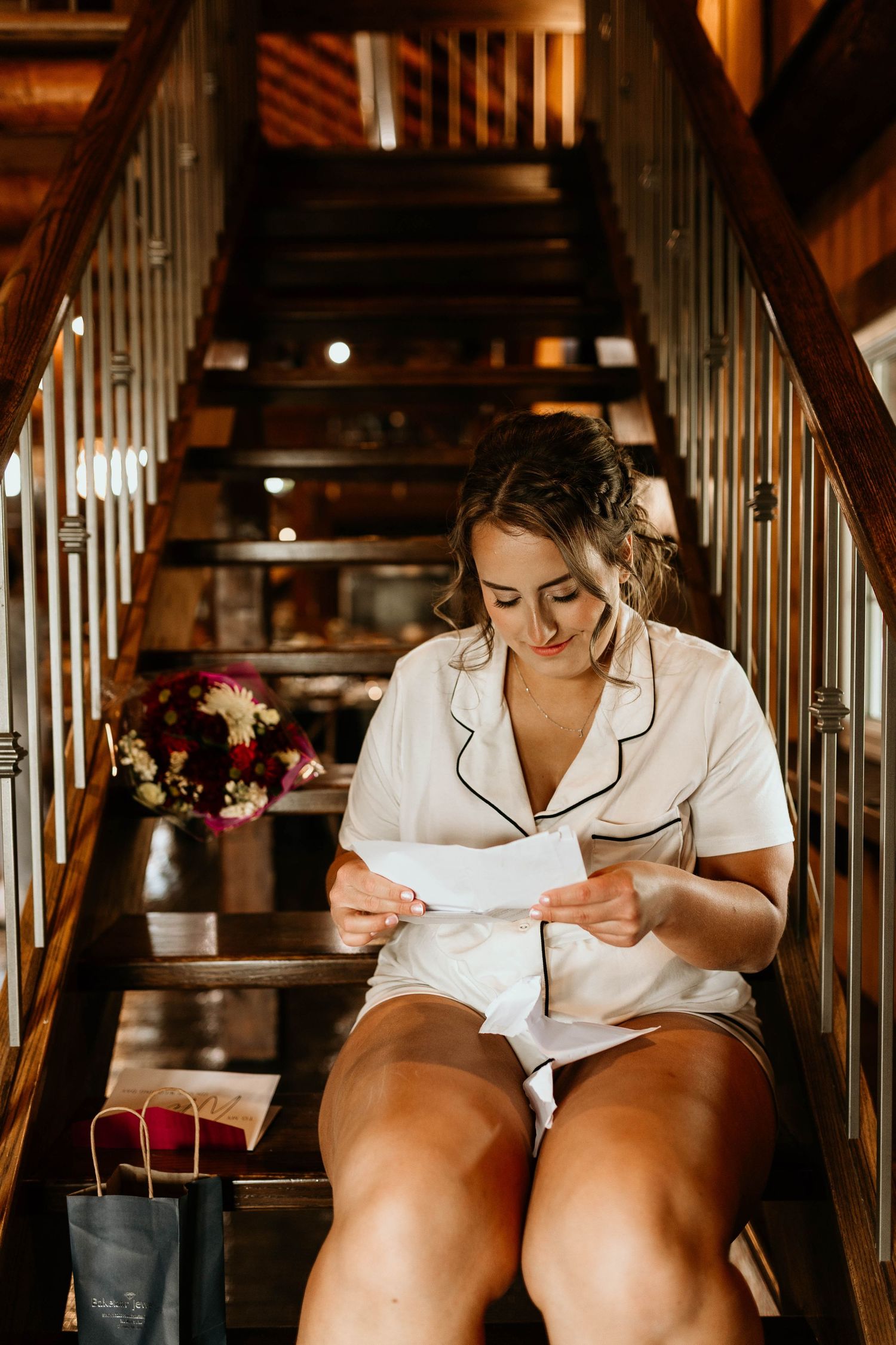 Four connected photos show someone in white pajamas sitting on wooden stairs in a rustic indoor setting.