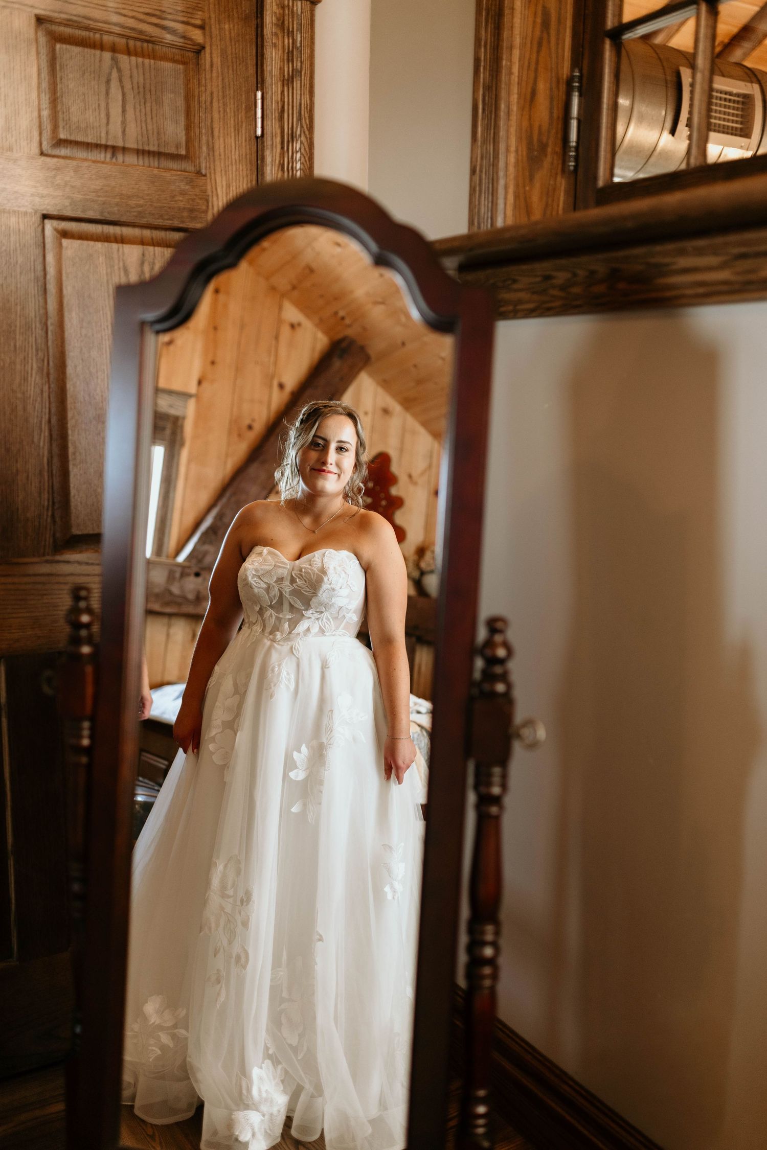 A sequence of four photos showing a white lace wedding dress in a rustic wooden hallway setting.