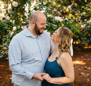 Couple laughing together during an outdoor autumn engagement photo session.