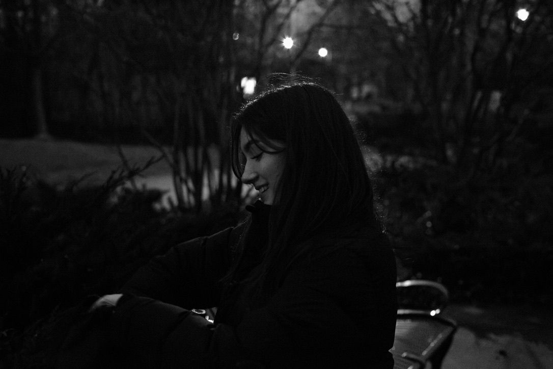 Black and white photo of a girl looking at a camera