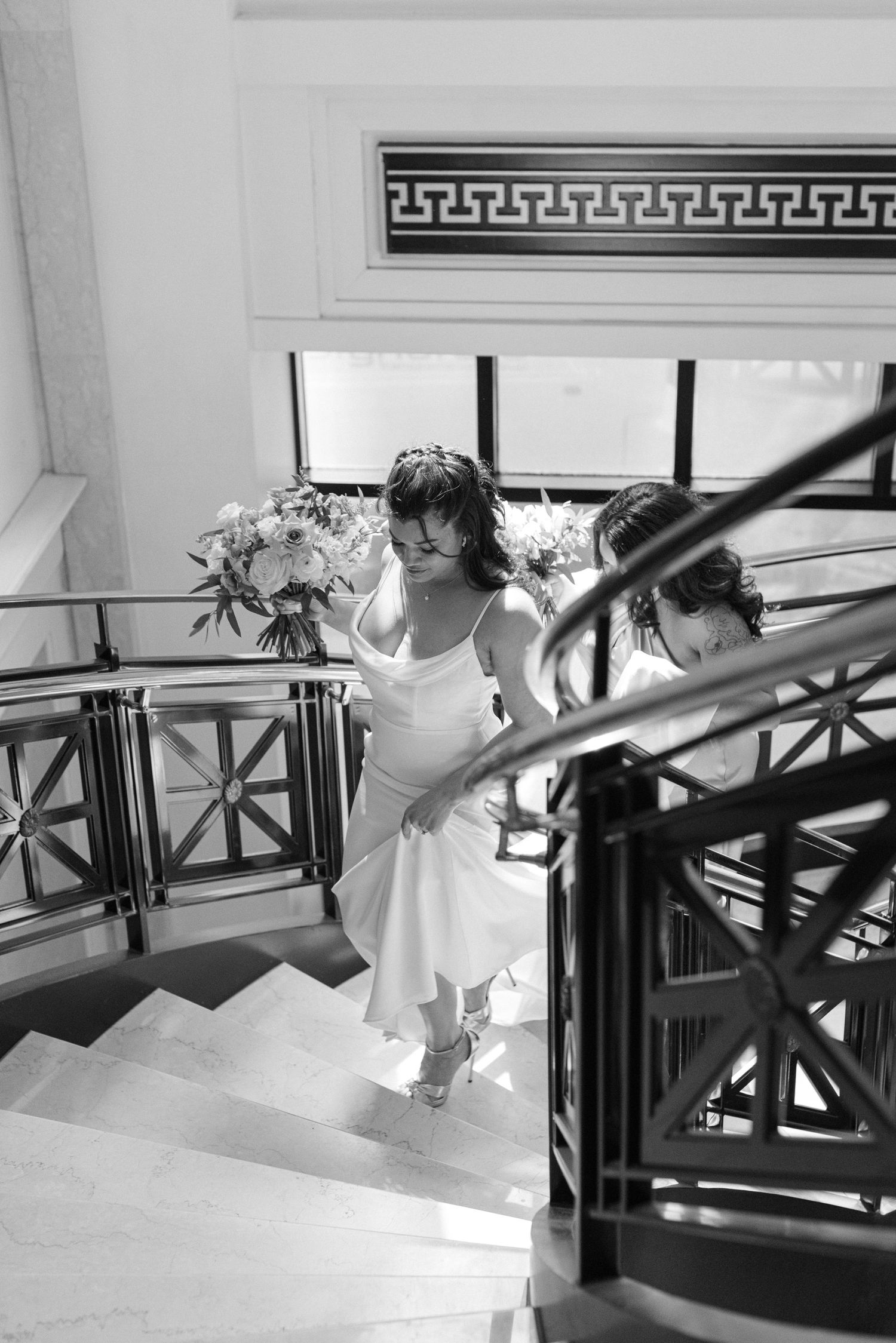 Elegant staircase with decorative railings and architectural details in black and white.