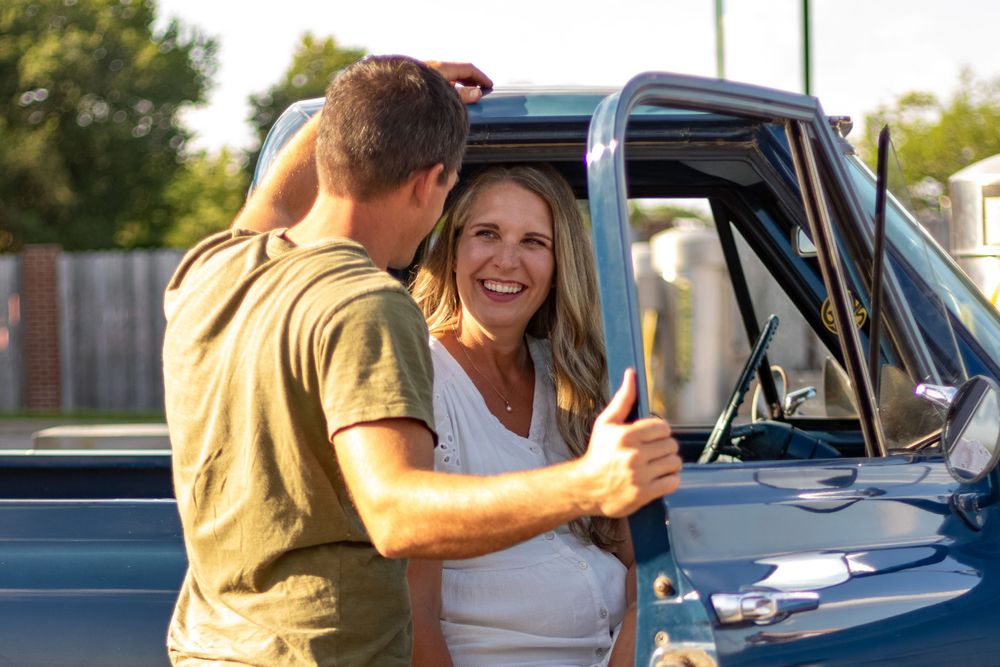 Vintage car photography session featuring classic blue automobile outdoors.