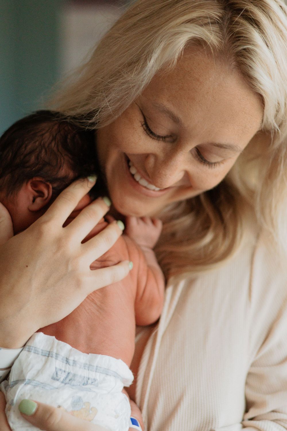 Intimate portrait of a tender moment between mother and newborn.
