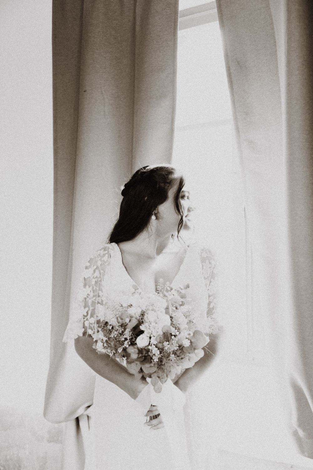 Ethereal black and white bridal portraits with soft window lighting.