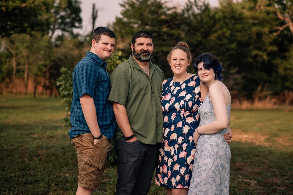 A portrait of a family of 4 posing for their Family Portrait Session.