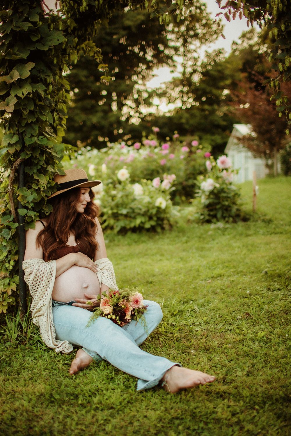 A dreamy garden scene with light crochet top and jeans in soft natural lighting.