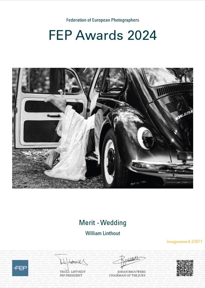 A black and white wedding photo showing a bride's dress next to a vintage car door.