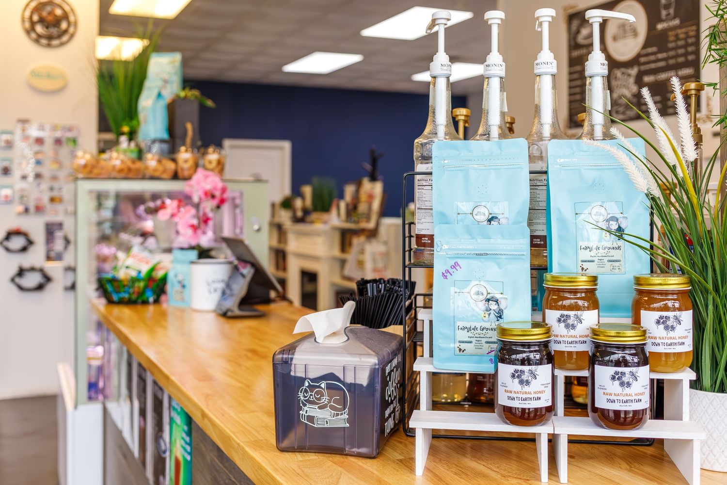 Local store display featuring artisanal jams and products arranged on wooden shelving with rustic decor.