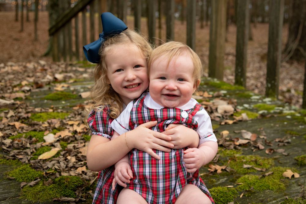family photo of brother and sister hugging in Tupelo