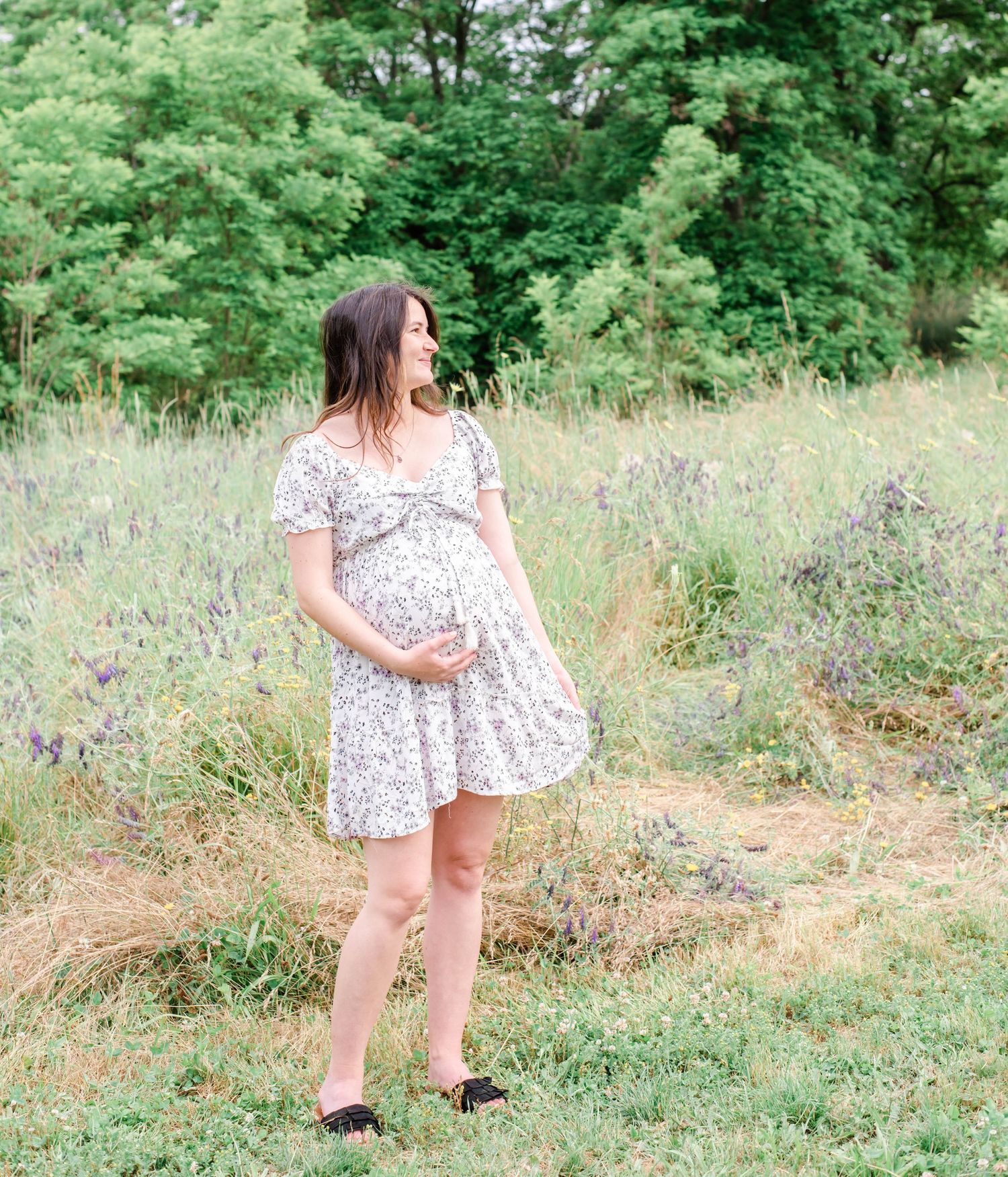 Casual outdoor photos taken in a meadow featuring a flowing white floral dress.