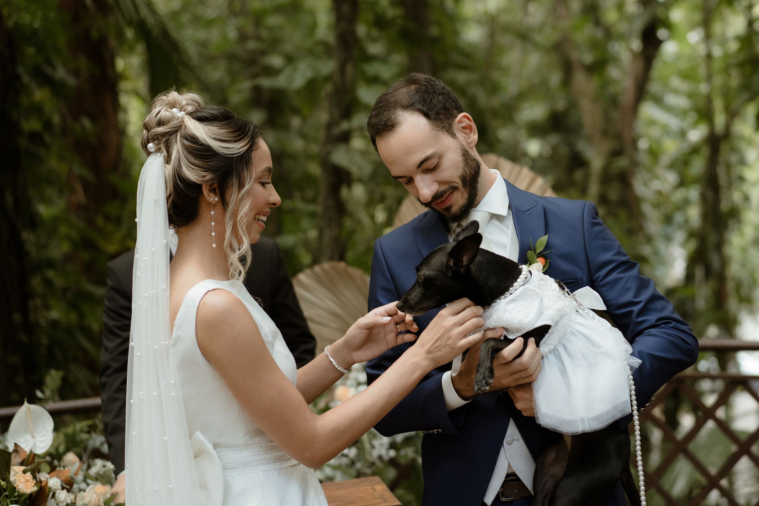 A special moment during a wedding ceremony as the couple interacts with their pet.