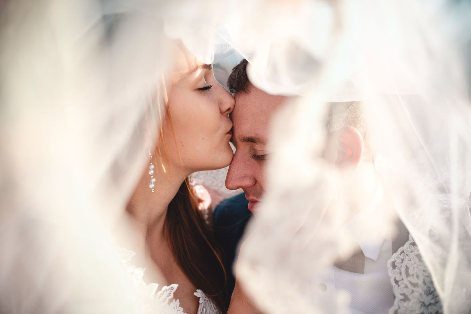 An intimate wedding portrait showing a couple's tender moment together.