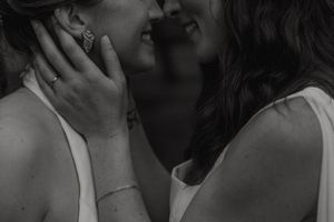 A black and white photo collage shows people sharing intimate moments and embraces in various candid shots.