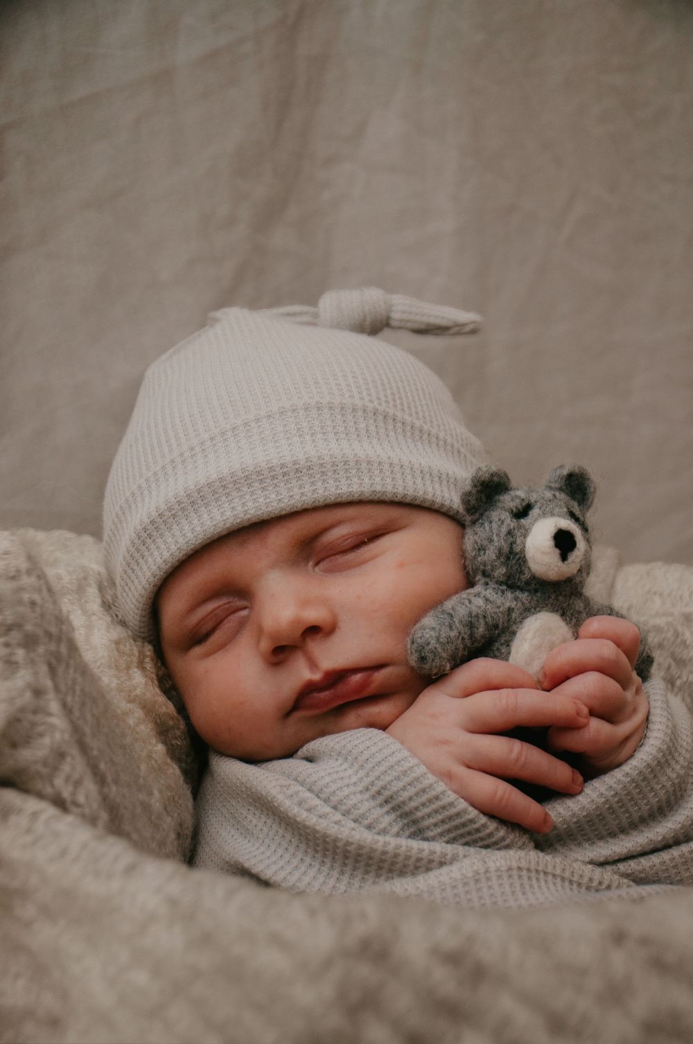 newborn photo. baby boy sleeping with teddy
