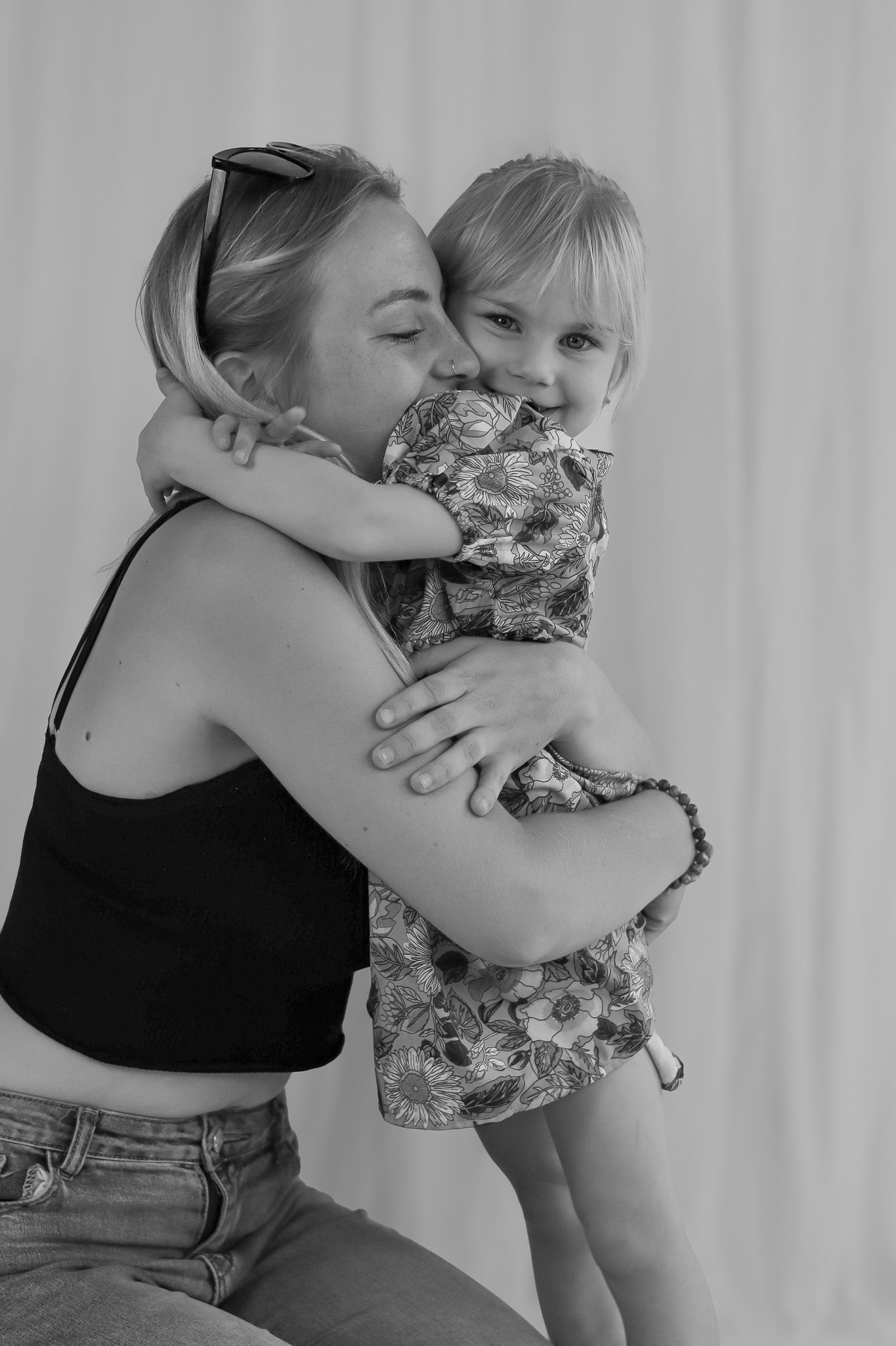Black and white photo showing an affectionate embrace between parent and child.