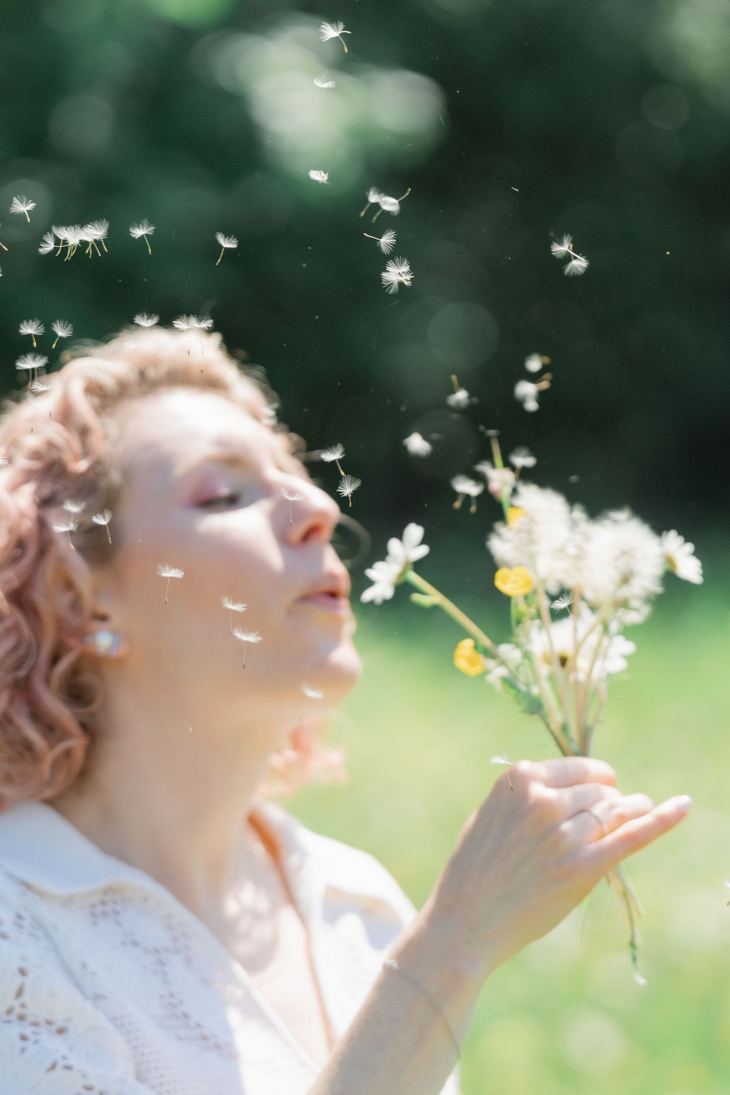 A playful engaged woman photographed in a vibrant wildflower meadow, showing the idyllic charm of the Swiss countryside.