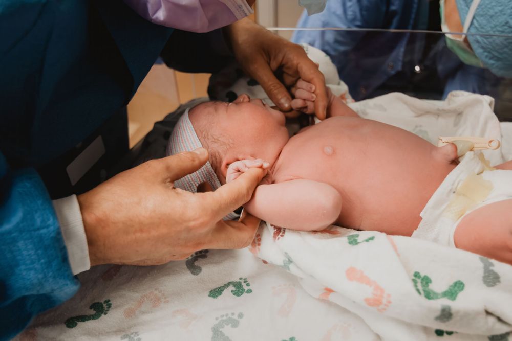 Healthcare provider performing medical examination in clinical setting.