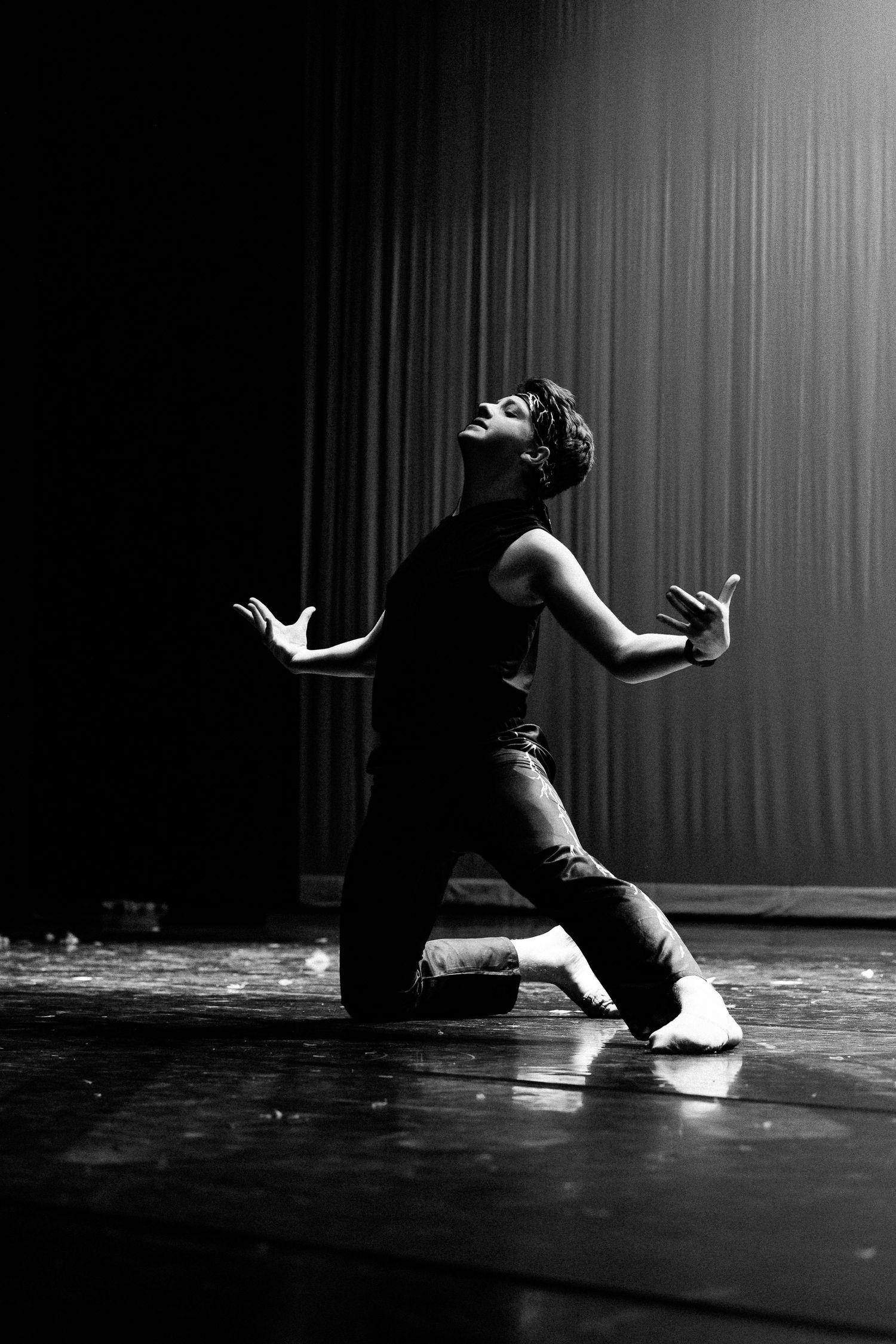 Dramatic black and white dance performance sequence on stage.