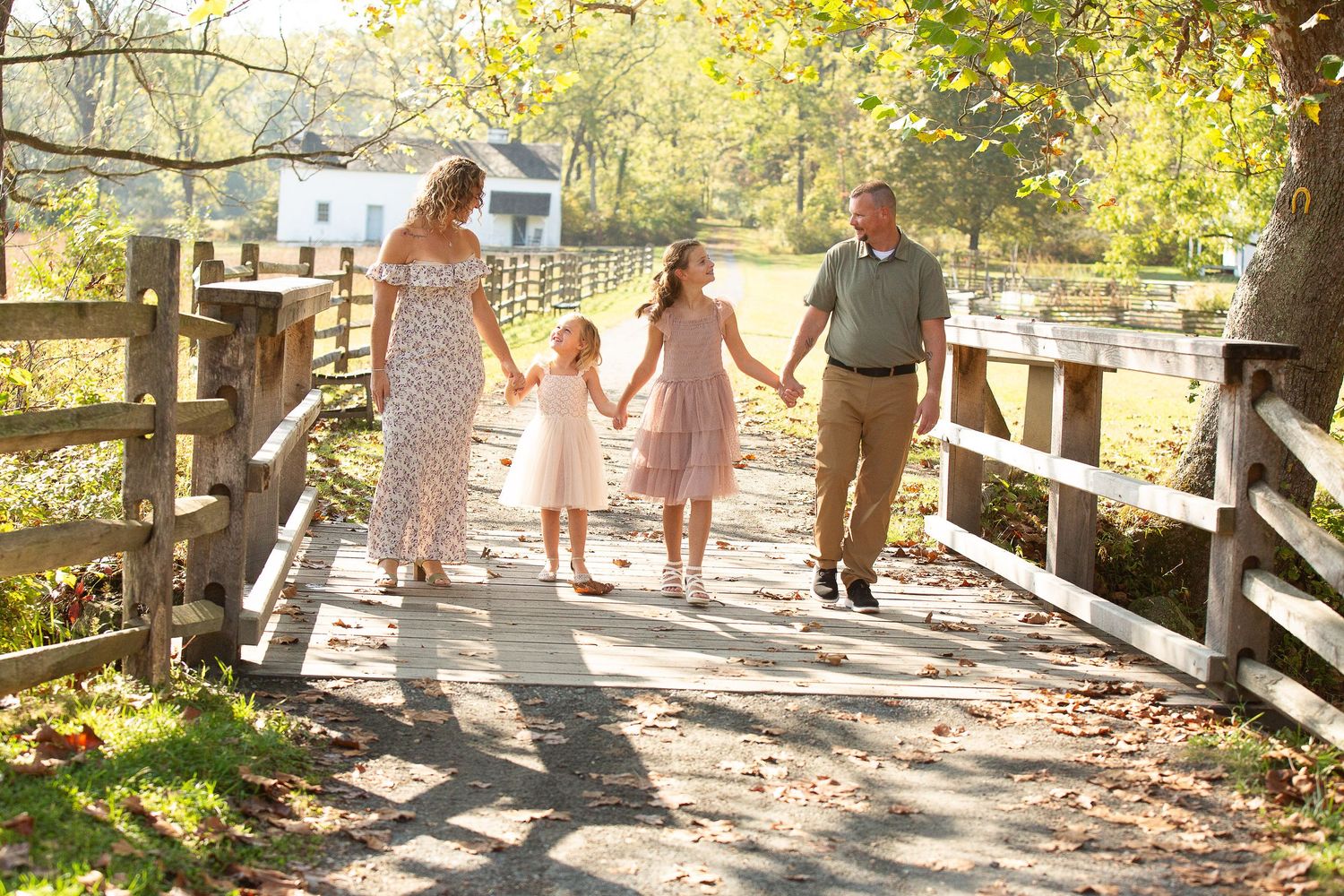 Family lying together on wooden deck for casual outdoor photo session.