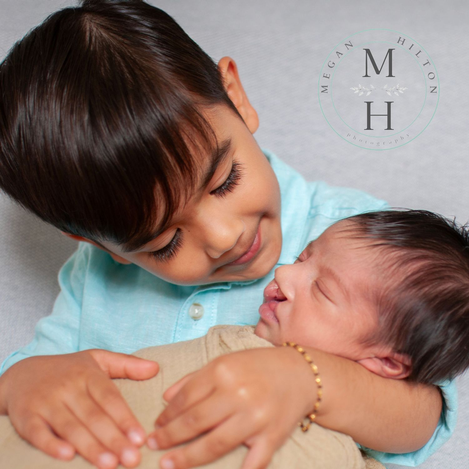 big brother holding baby