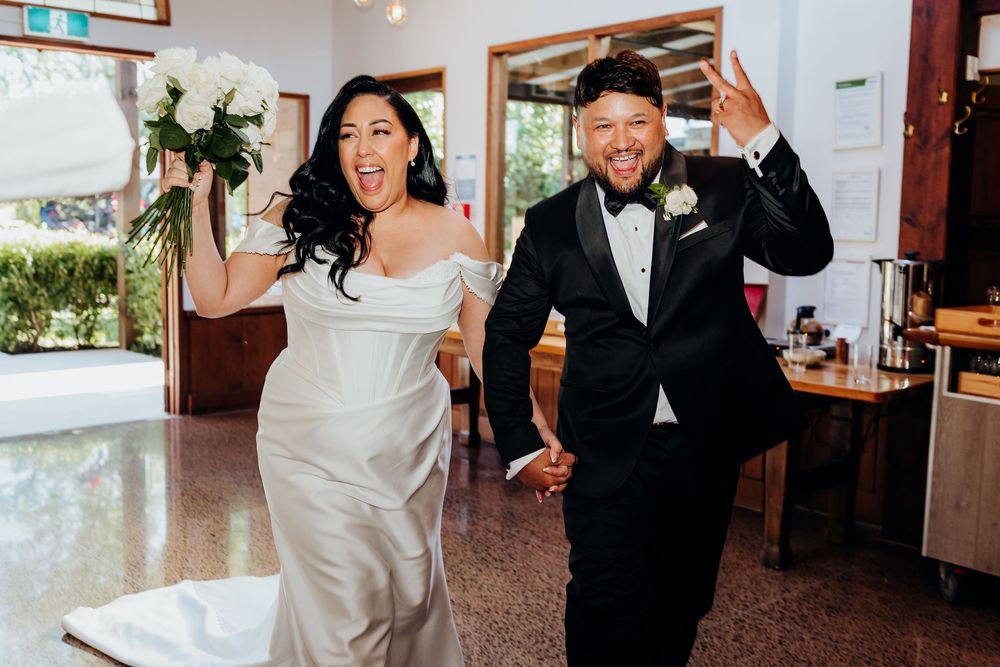 A couple in wedding attire dances together during their reception celebration.