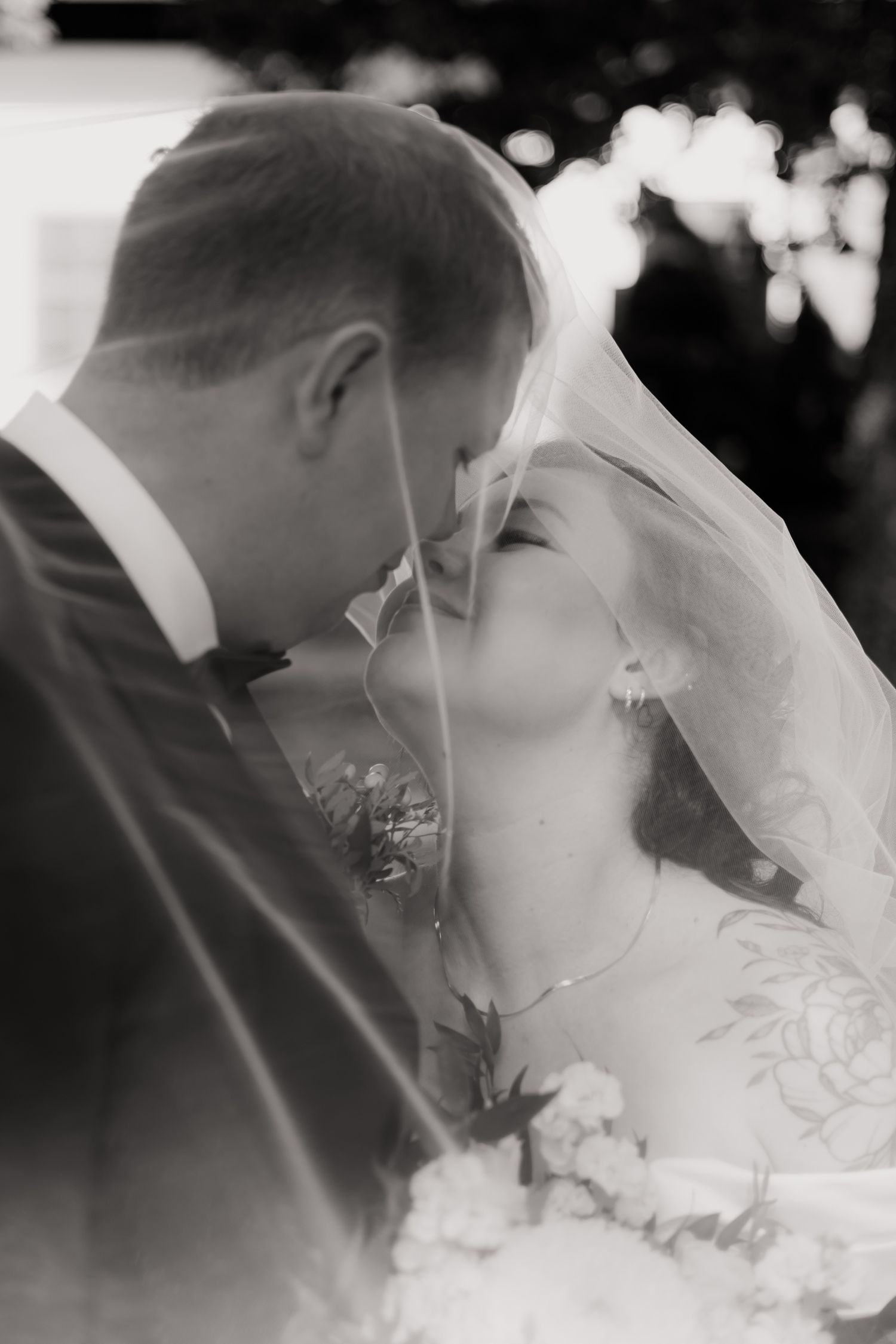 Elegant wedding veil flowing in the breeze captured in black and white.