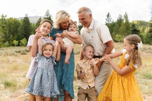 Joyful multigenerational family sharing a candid moment outdoors.