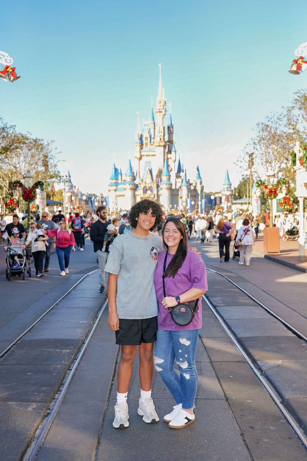 A series of photos showing visitors posing on Main Street USA with Cinderella Castle at Walt Disney World in the background.
