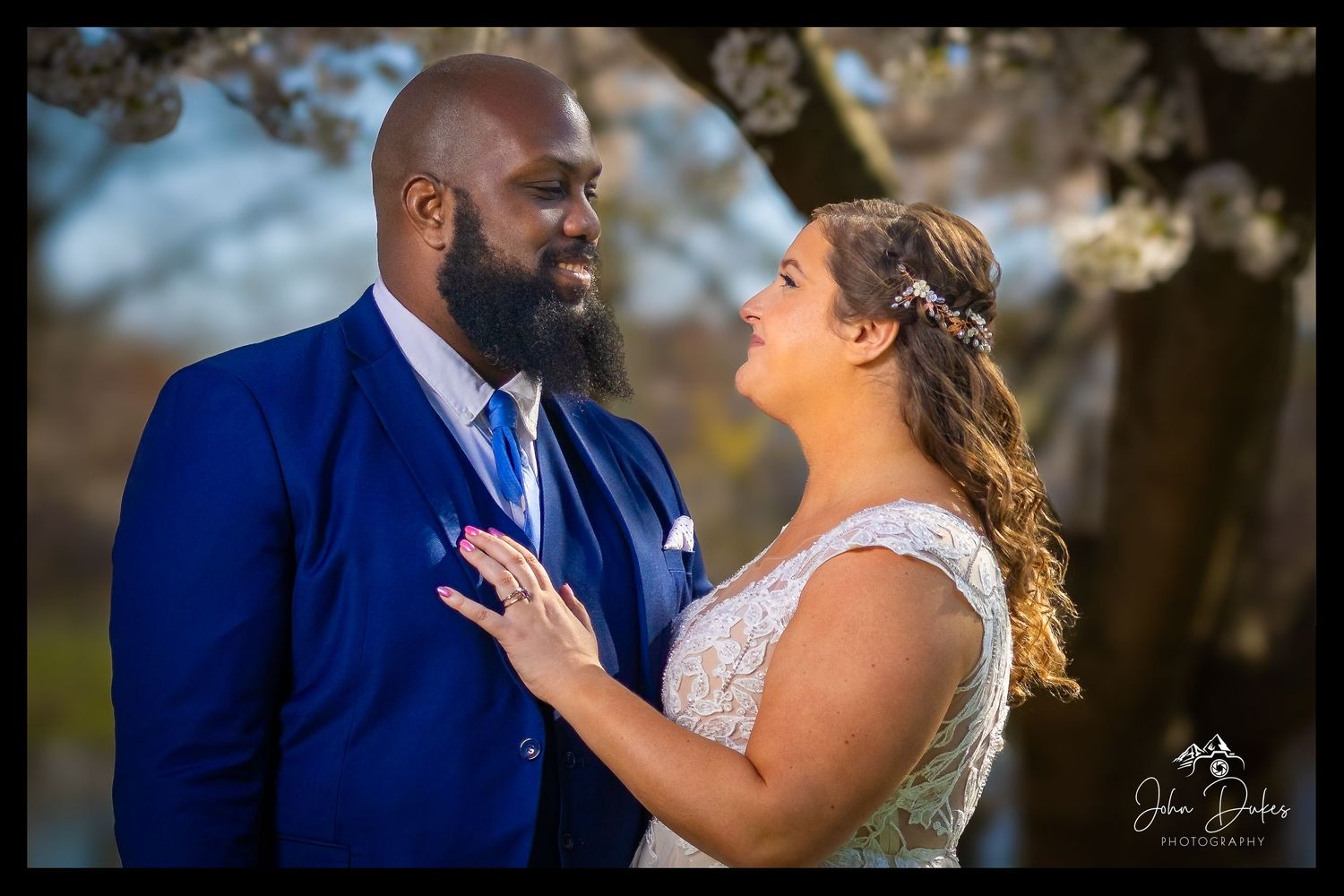 Wedding couple shares intimate moments during outdoor portrait session in natural light.