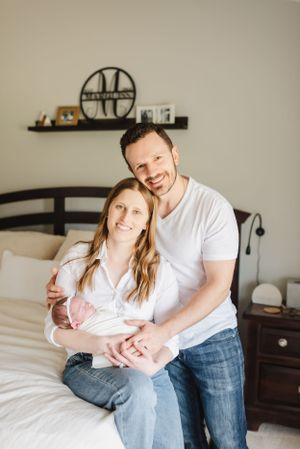 Denver Colorado Newborn Photographer poses family with dog in their newborn's nursery. In home, lifestyle newborn photographer. Candid photo
