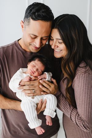 studio newborn session including parents and baby in Colorado