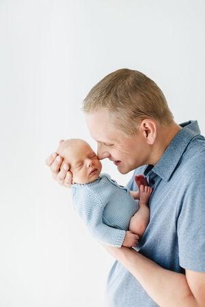 In studio newborn photographer for family and baby photos. Daddy and me photos with newborn at studio in Centennial Colorado