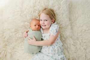 In studio newborn photographer for family and baby photos. Sibling photos with newborn at studio in Centennial Colorado